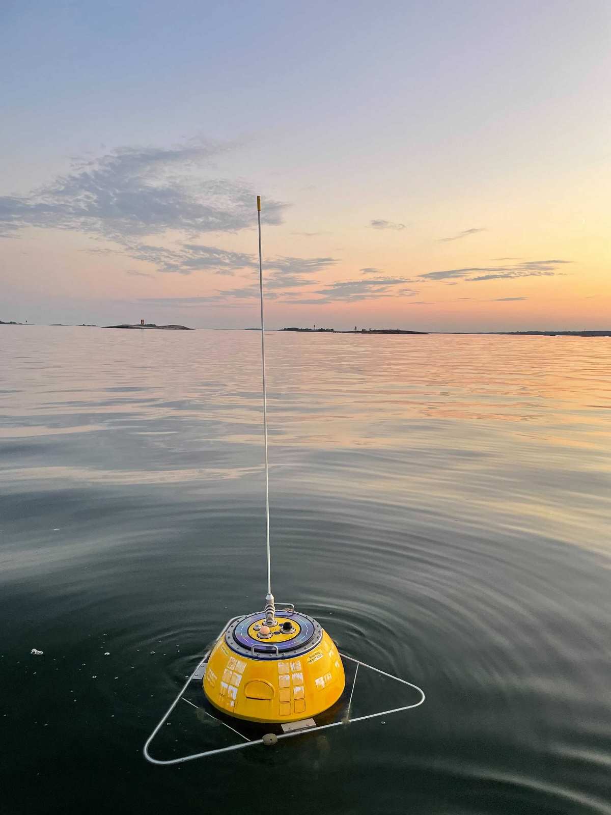 Yellow buoy in a still water at sunset.