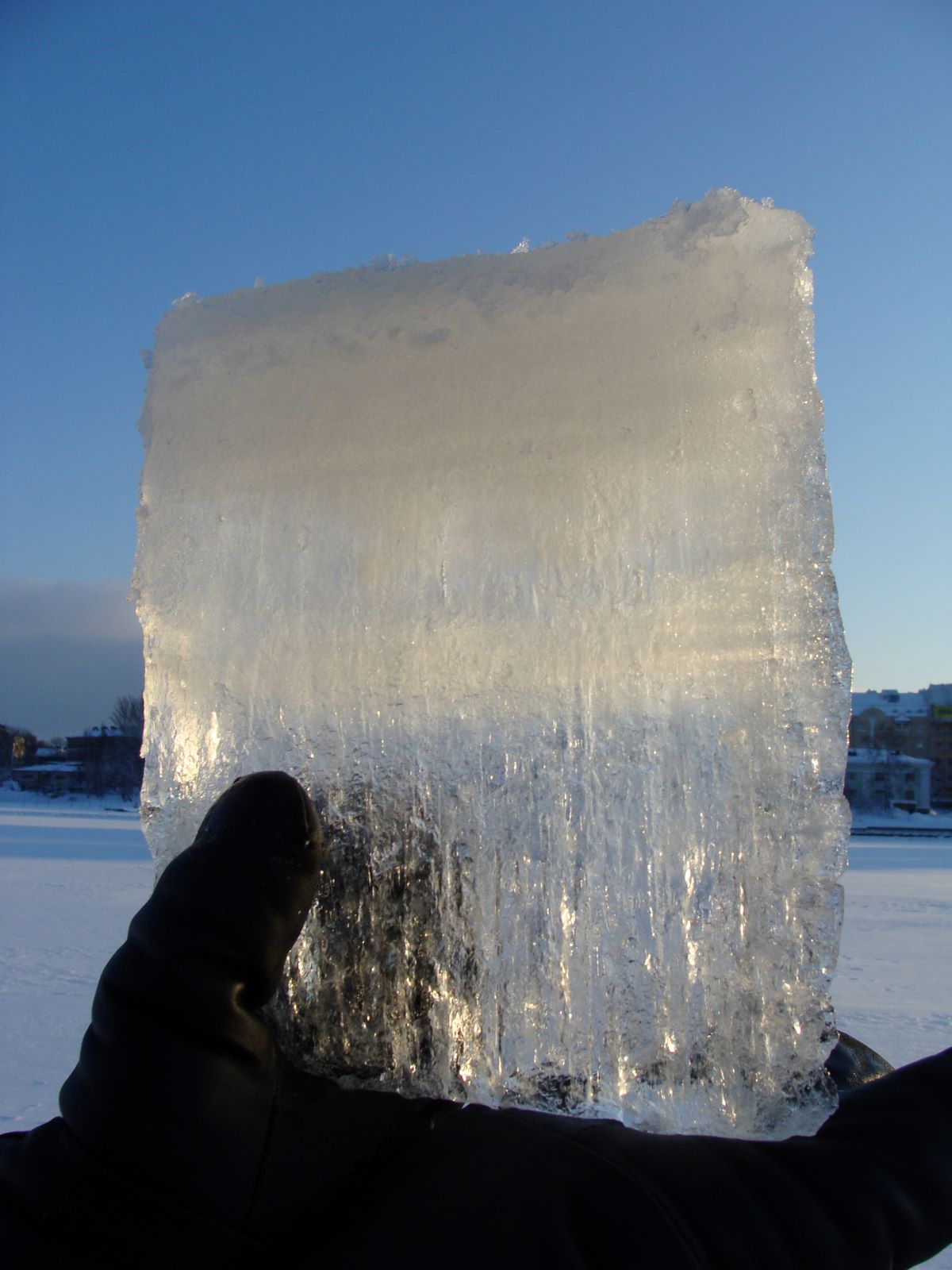 Upper part of the ice cube is white and lower part transparent.