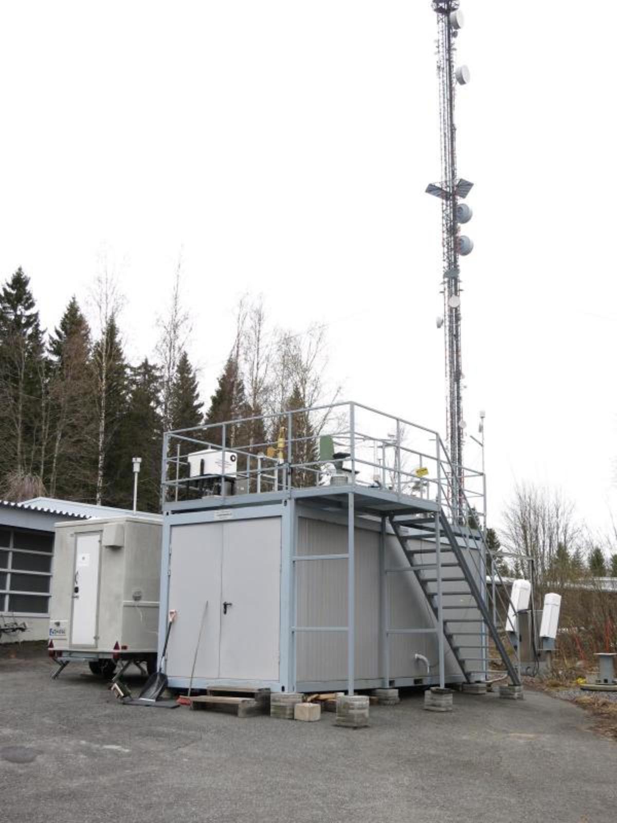 Measurement site at Vehmasmäki in Kuopio, nearby the radio and television transmitting mast. Finnish Meteorological Institute performs continuous measurements both in the mast and in, on, and next to a measurement container with several instruments.