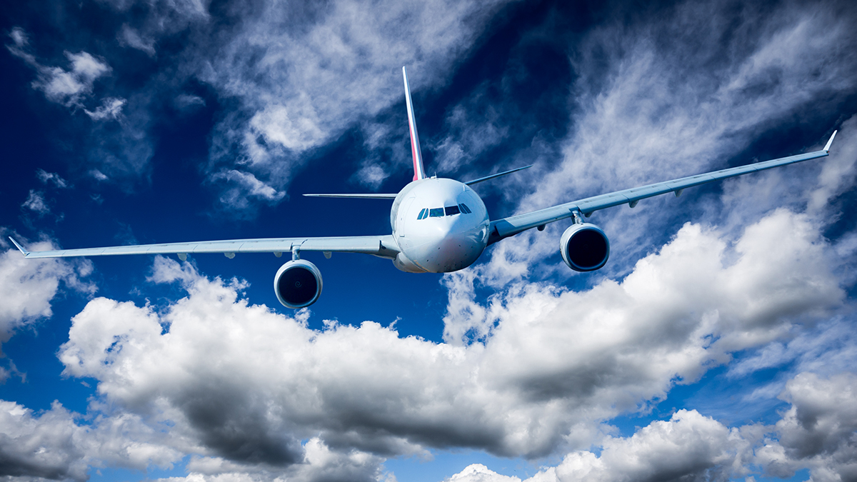 Airplane on the sky with clouds.