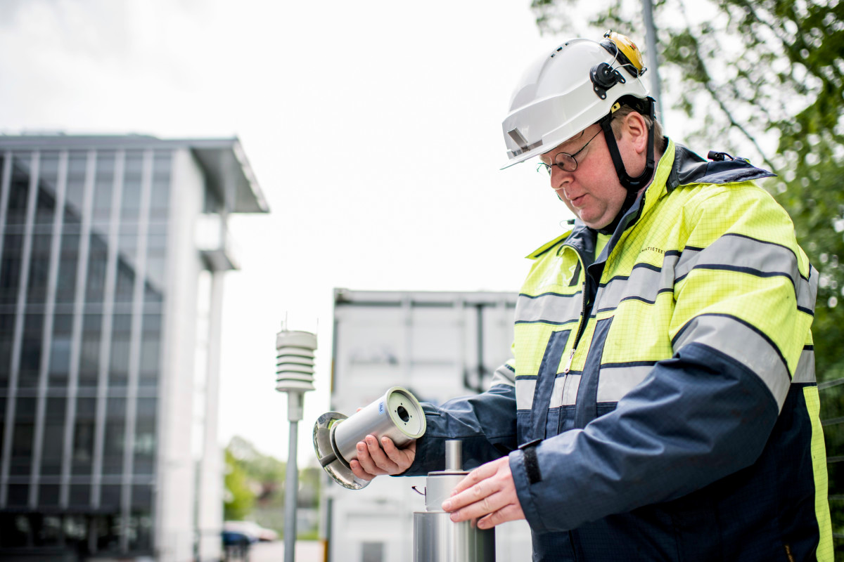 Scientist installing air quality measurement instrumentation